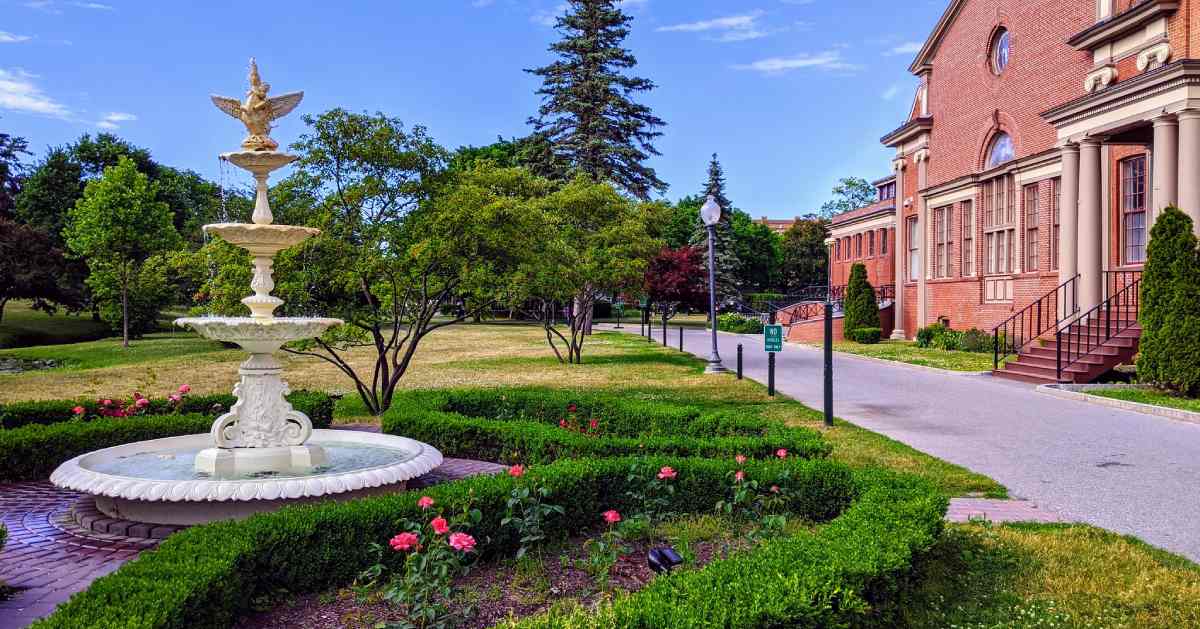 fountain in a park near a brick building