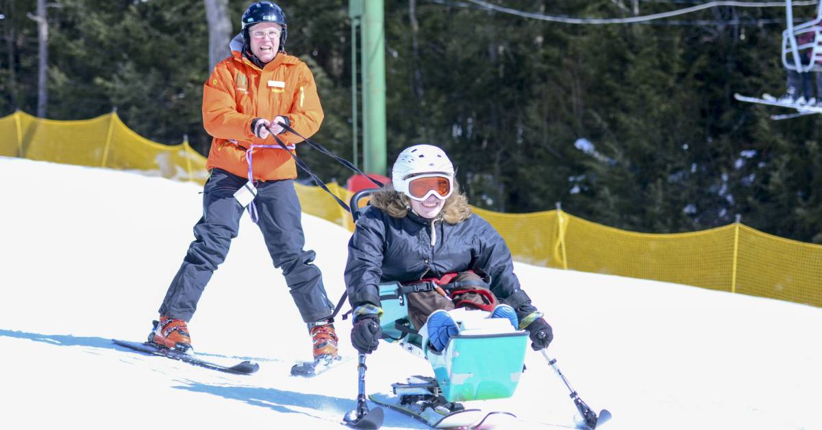 a kid and an instructor skiing at double h ranch