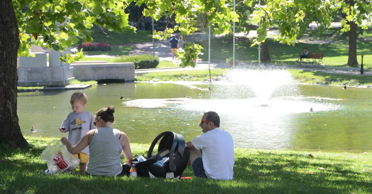a family having a picnic by a pond in congress park