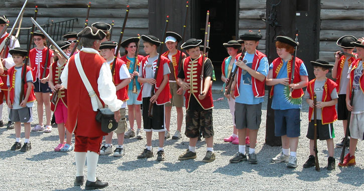 kids doing an activity with a reenactor at fort william henry