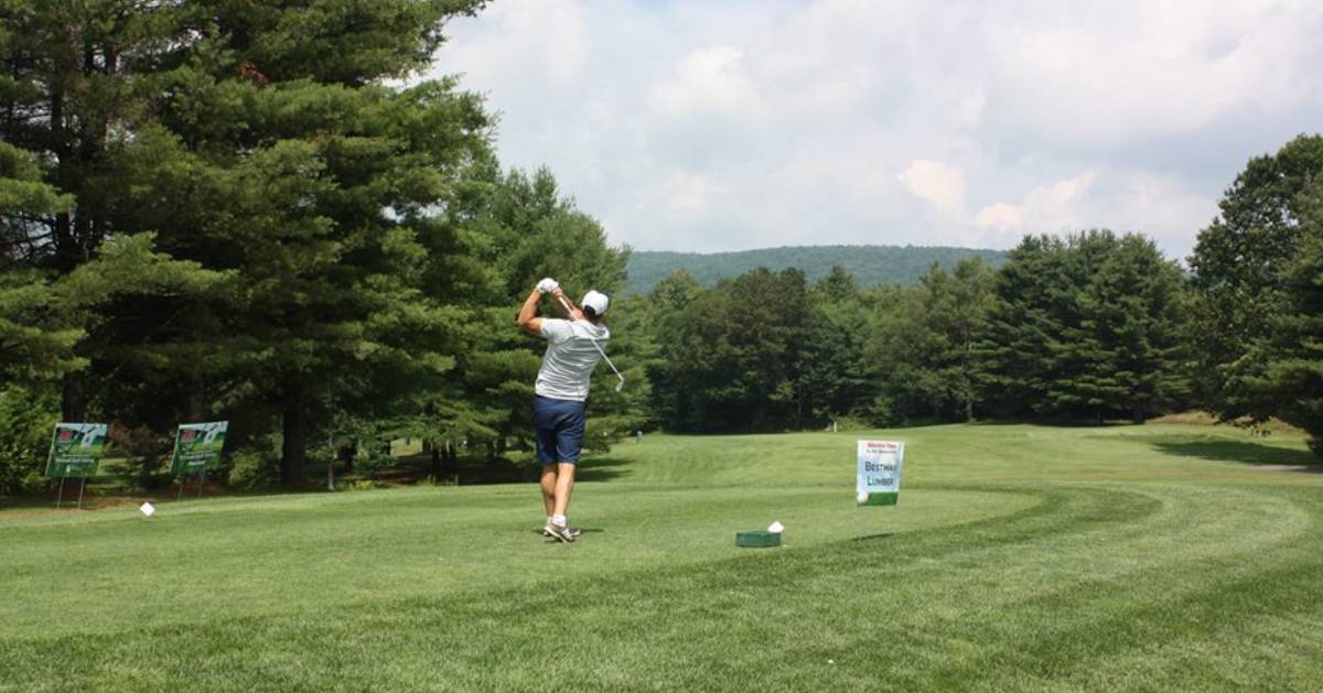 golfer swinging on course