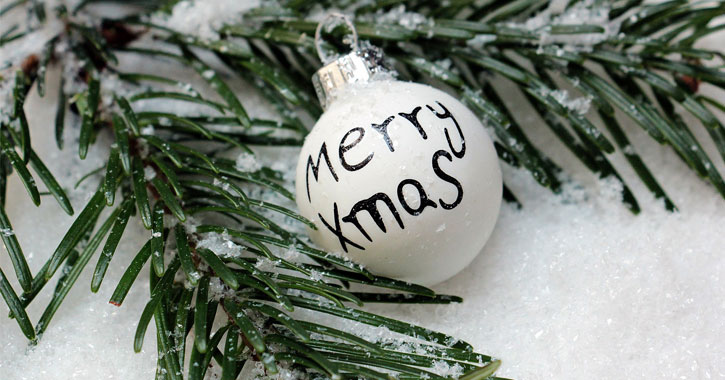 white merry christmas ornament on snow