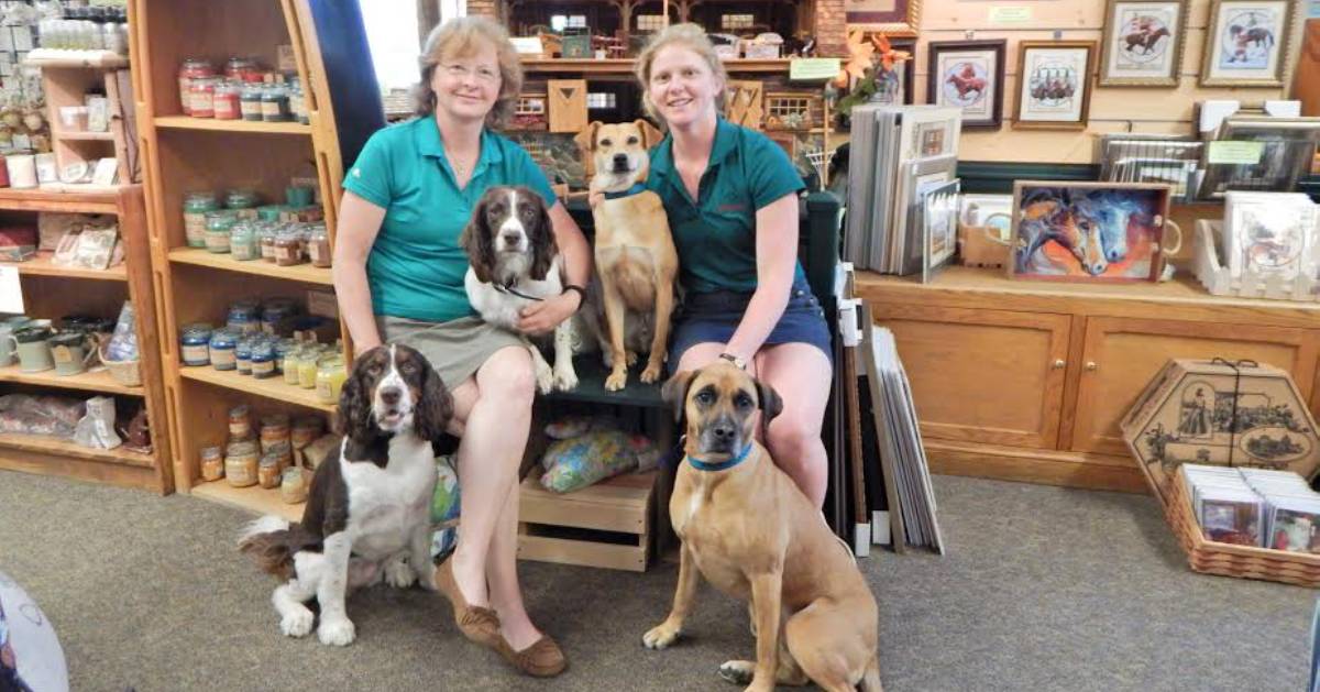 two women with dogs in a store