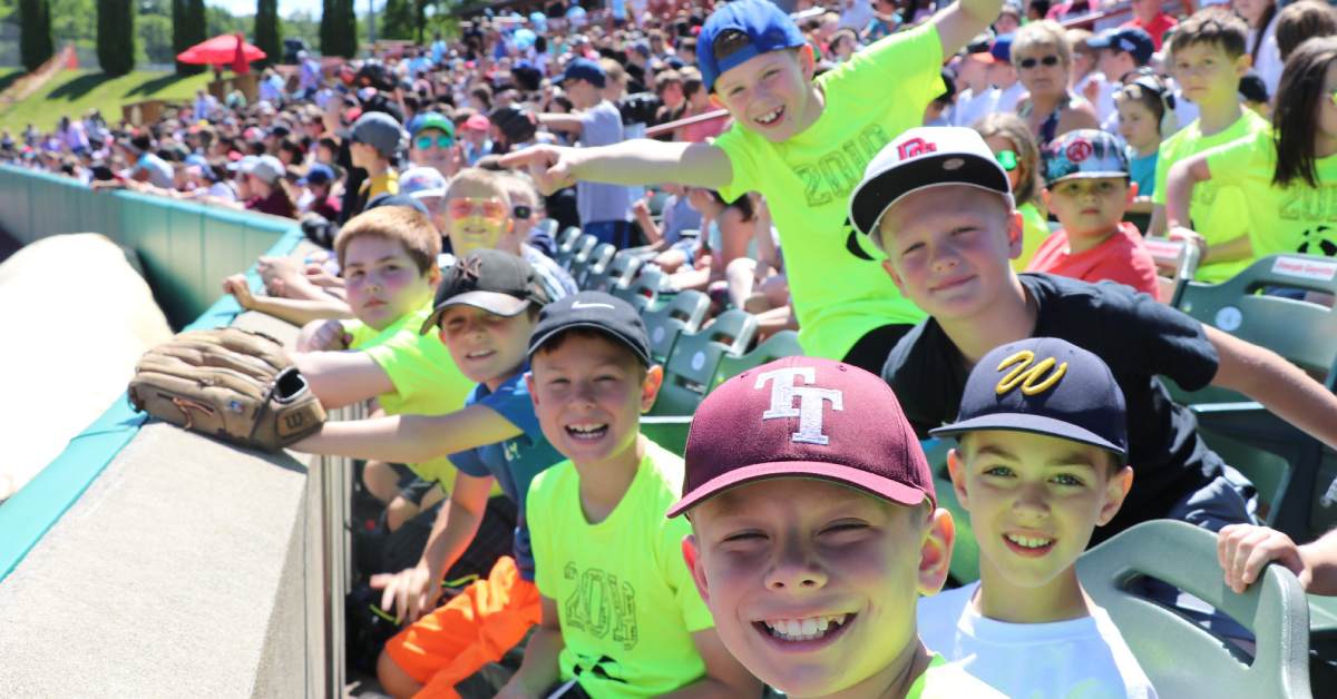 kids smiling at a baseball game