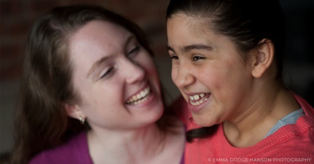 woman and young girl smiling together