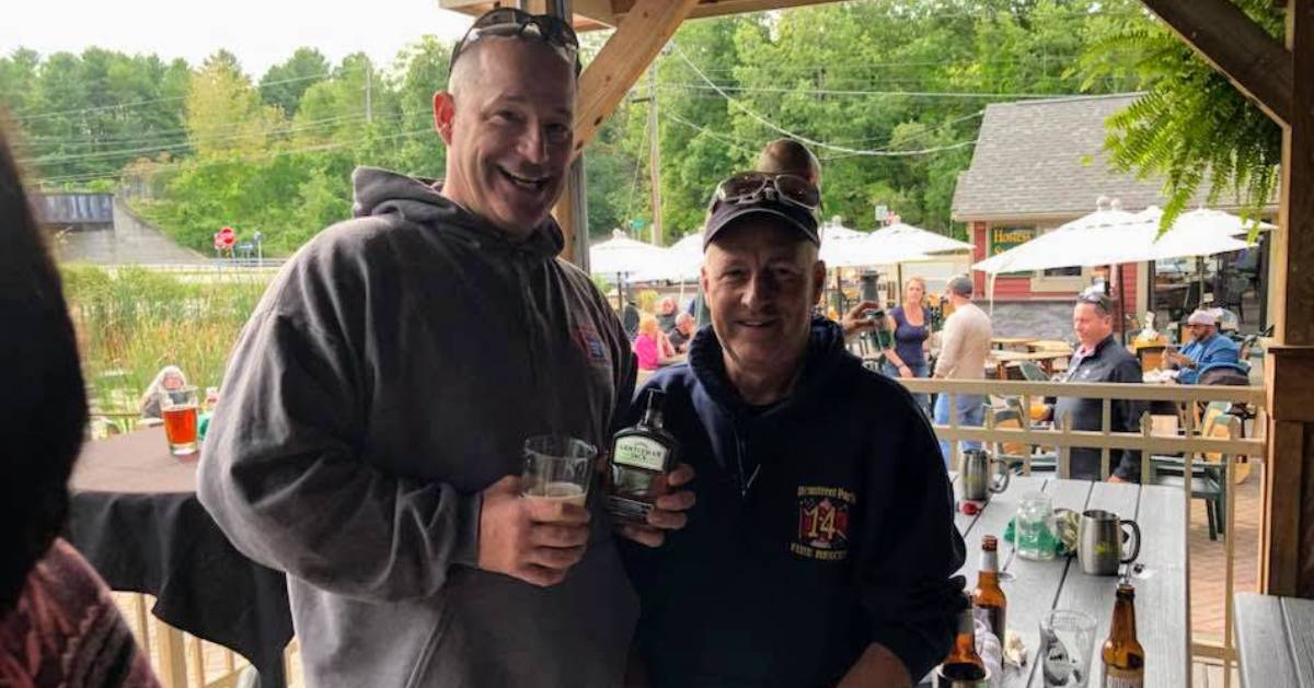 two guys posing, outdoor space at bar