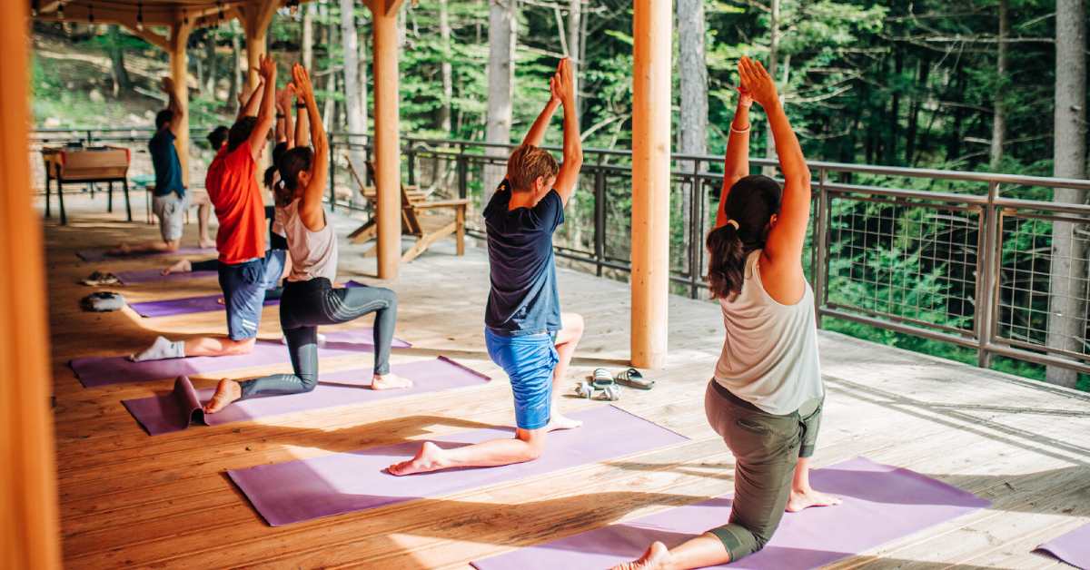 people doing yoga on a deck