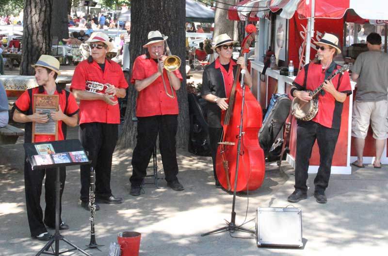 Band dressed in red and black playing at Saratoga Race Course