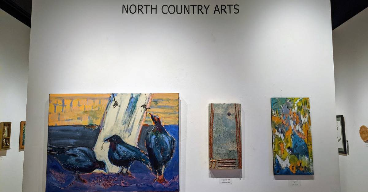 North Country Arts sign and paintings