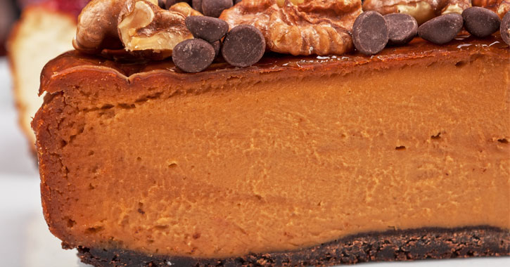 close up of a slice of pumpkin cheesecake