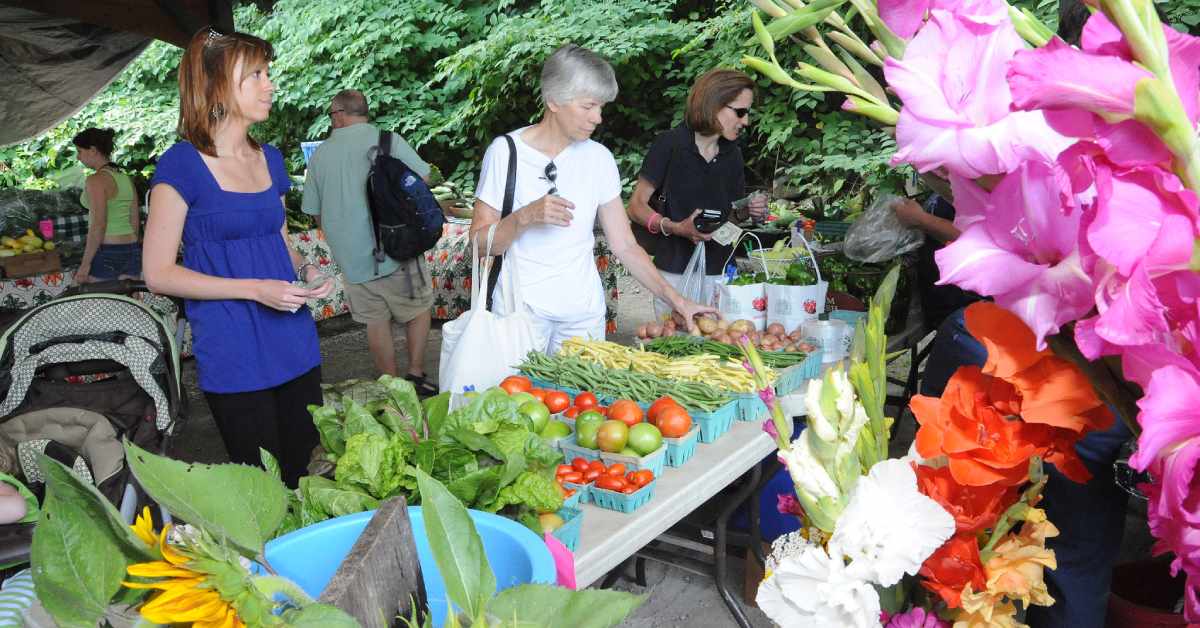 people shopping at outdoor farmers market