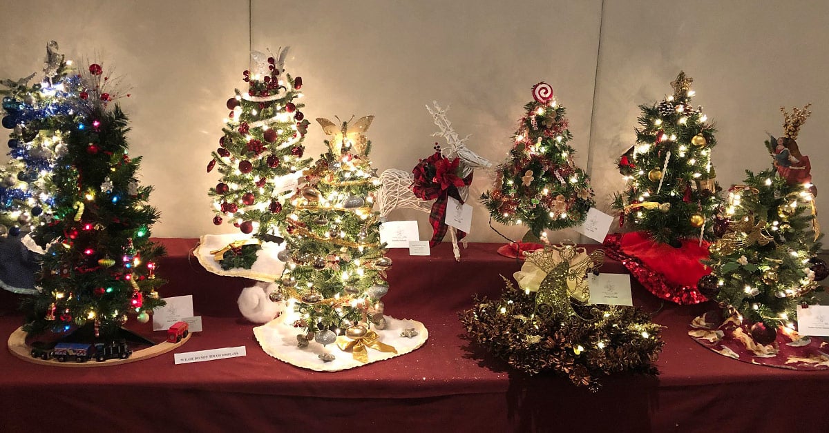 several small decorated trees on a table