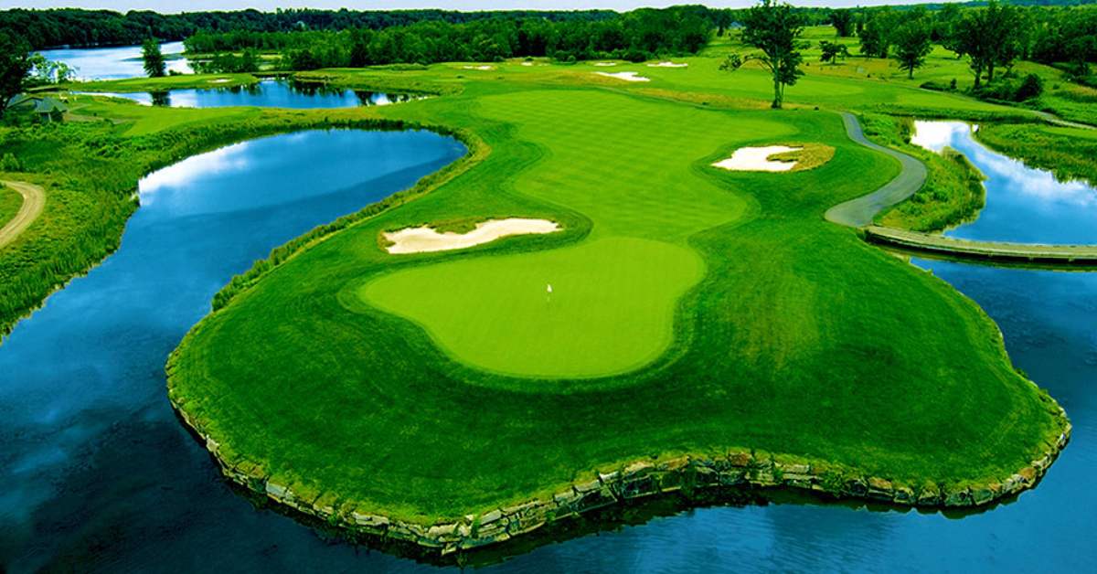 aerial view of green golf course and ponds