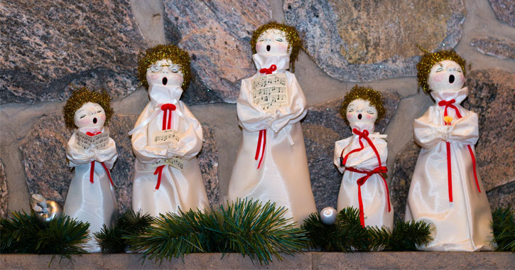 five figurines on a mantle singing