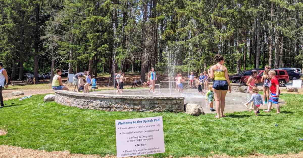 outdoor splash pad in a park with kids around it