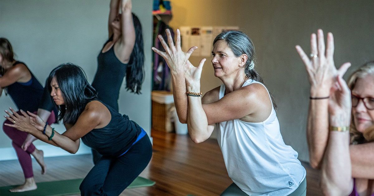 women doing yoga, eagle pose