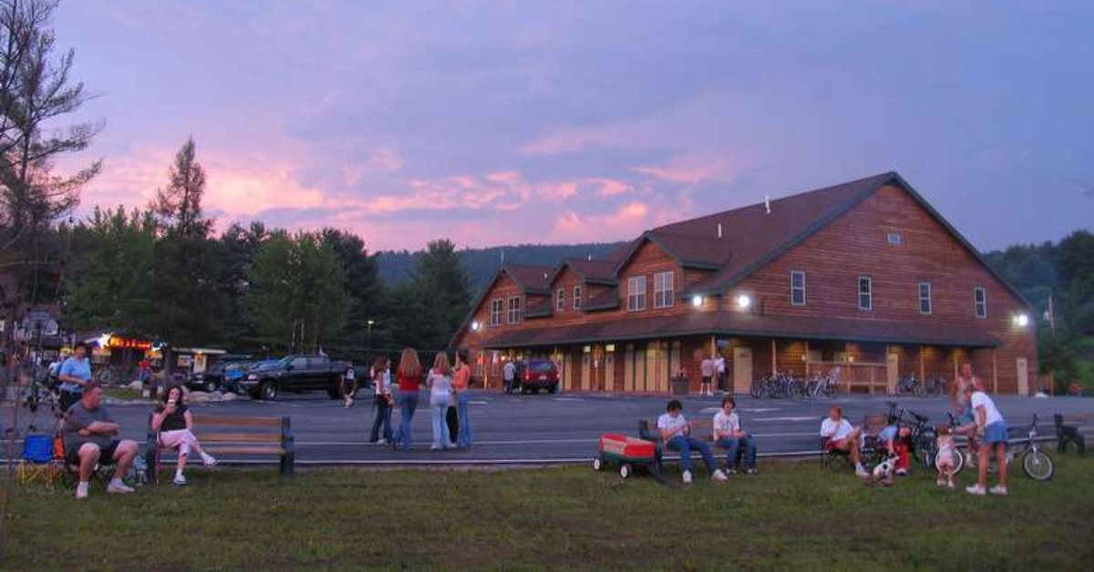 people hanging out in front of a lodge at lake george escape outdoor resort