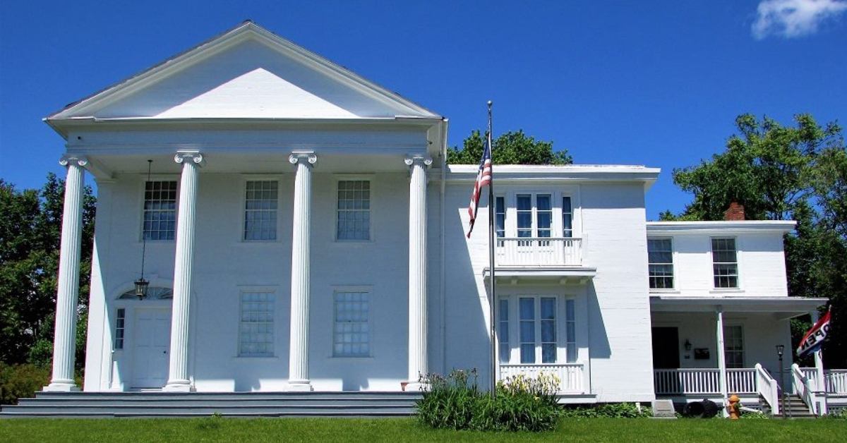 large white building with pillars at the front entrance