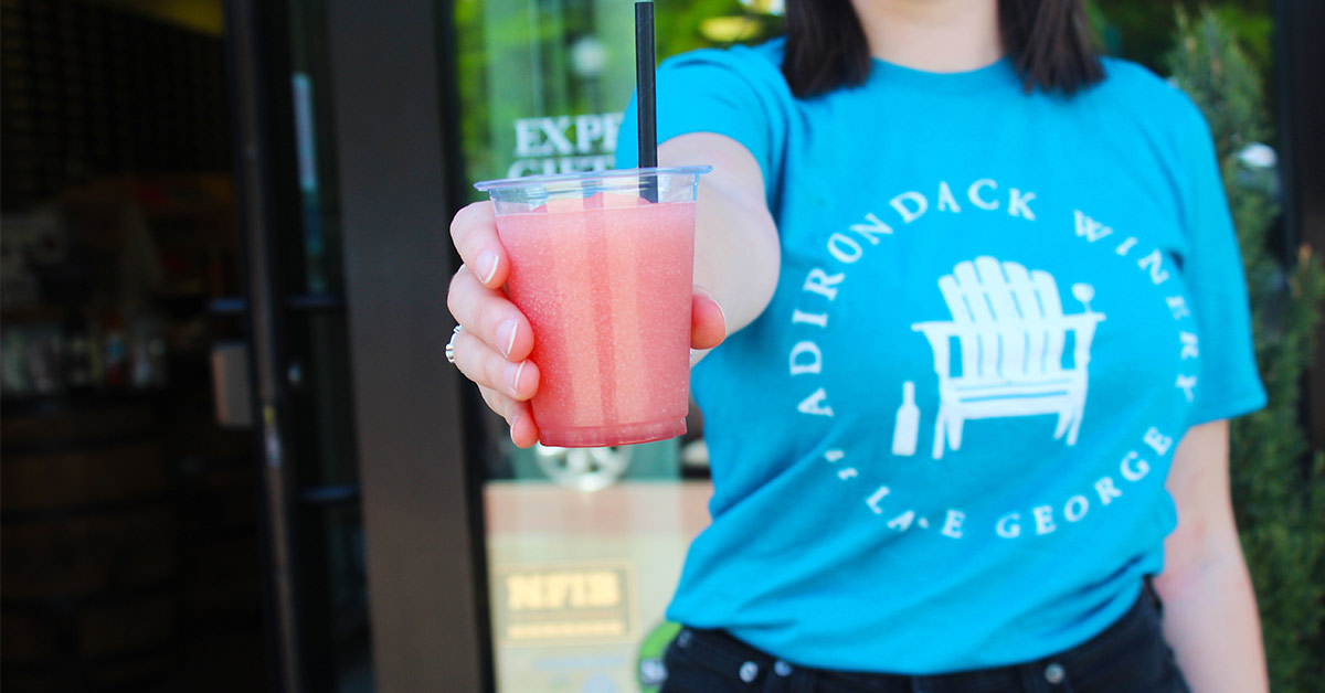 adirondack winery staff member holding a pink wine slushy