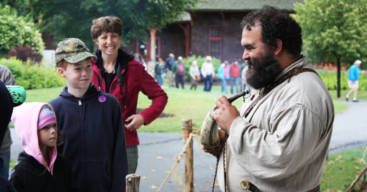 kids watching a costumed interpreter at adirondack experience