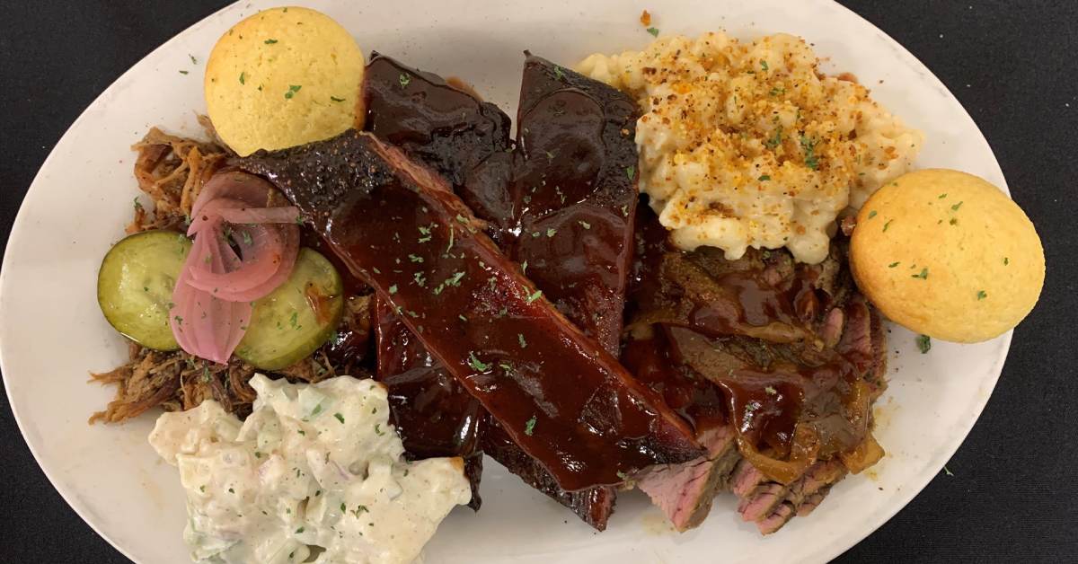 plate with bbq ribs, mac and cheese, and other sides