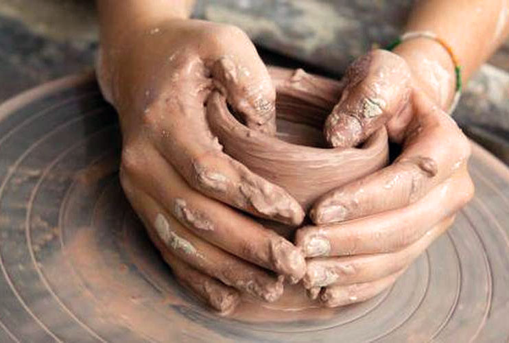 person using a pottery wheel