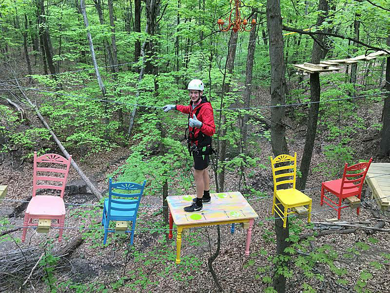 man traversing a ropes course