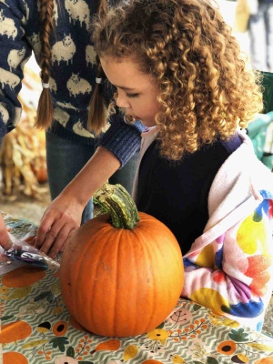 little girl with pumpkin