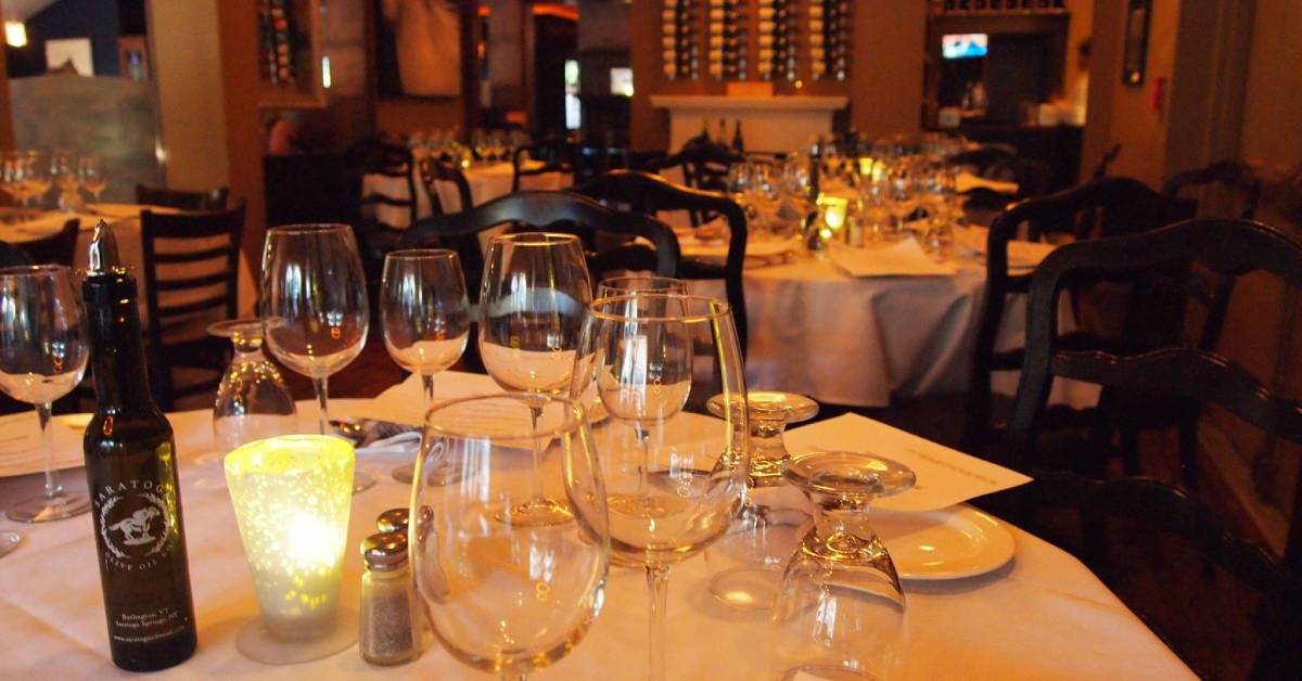 restaurant dining room with tables with wine glasses