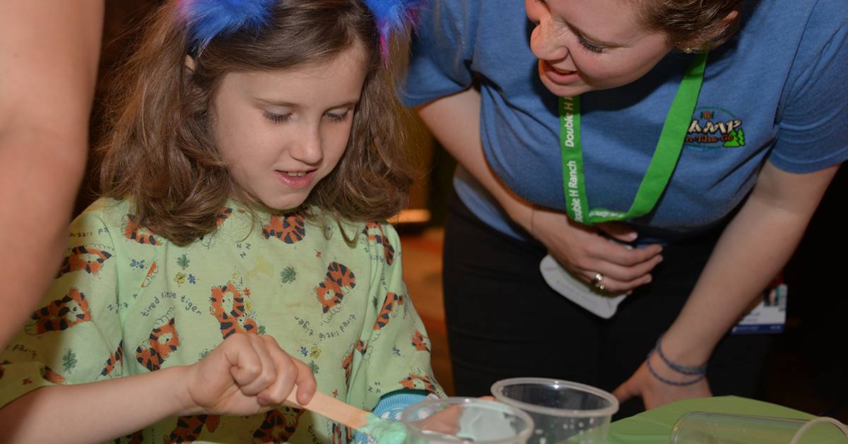 girl in hospital nightgown playing with paste for a craft