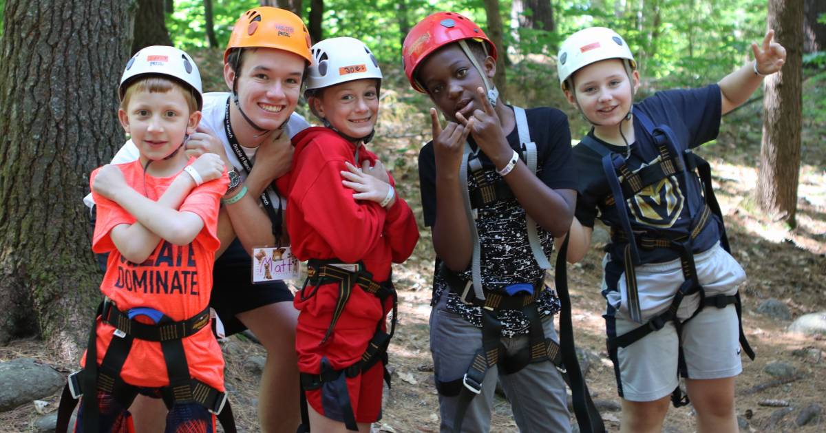 kids in helmets geared up for ropes course