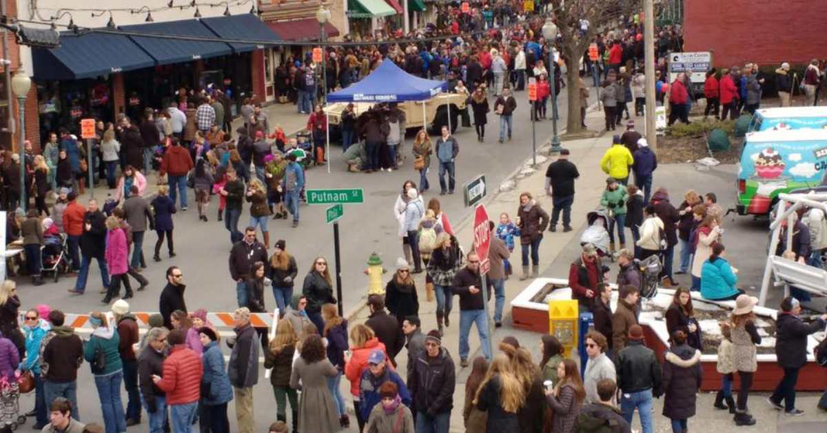 crowd of people walking around downtown