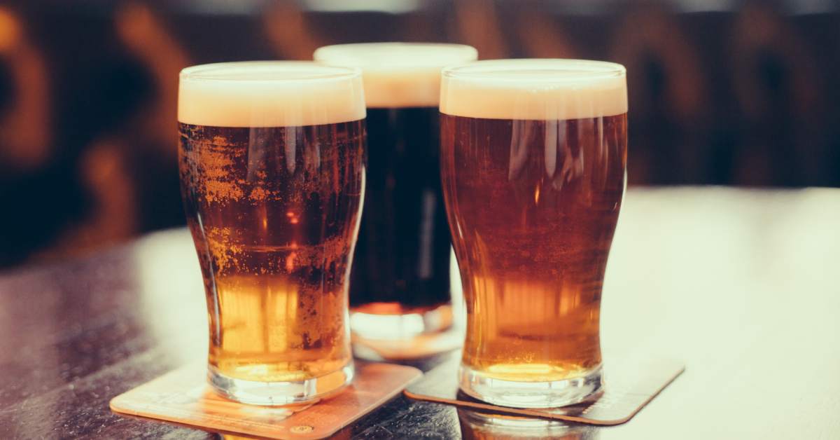 three glasses of beer on a table