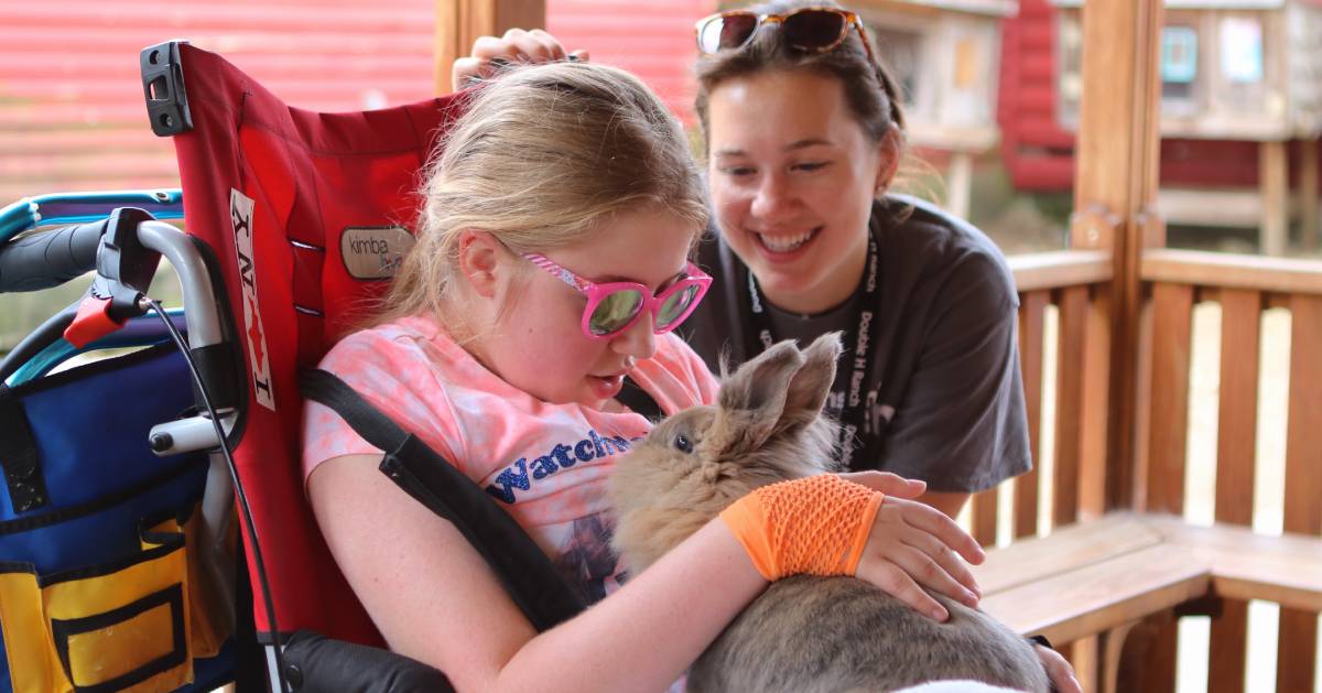 girl in wheelchair with bunny in her lap