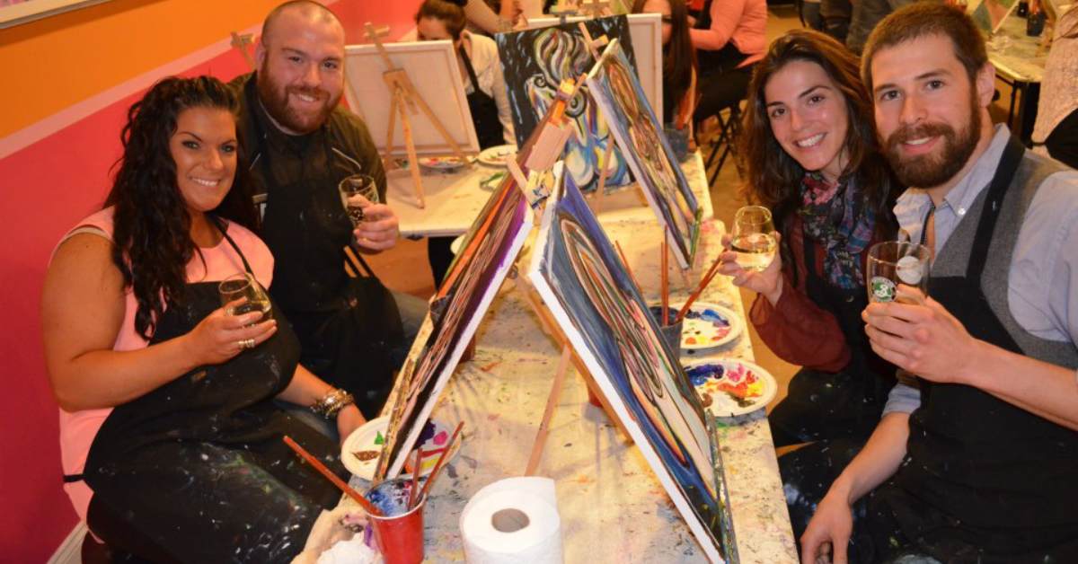 two men and two women at a paint and sip table