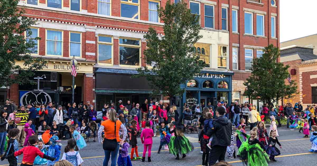 street filled with kids dressed up in halloween costumes