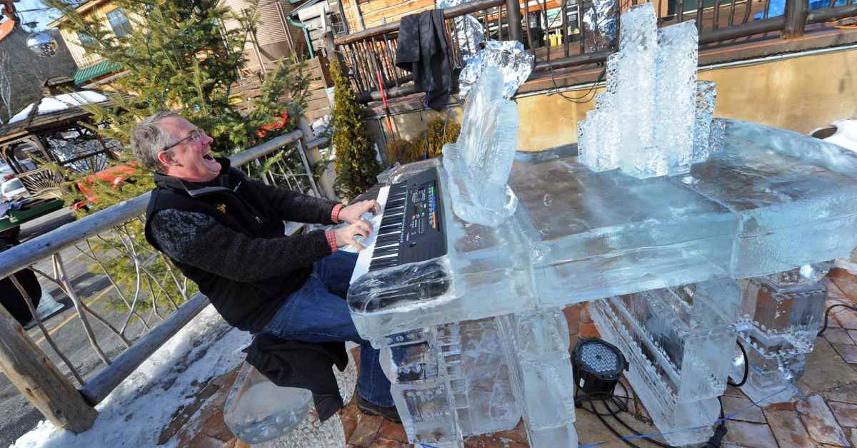 man having fun playing an ice piano