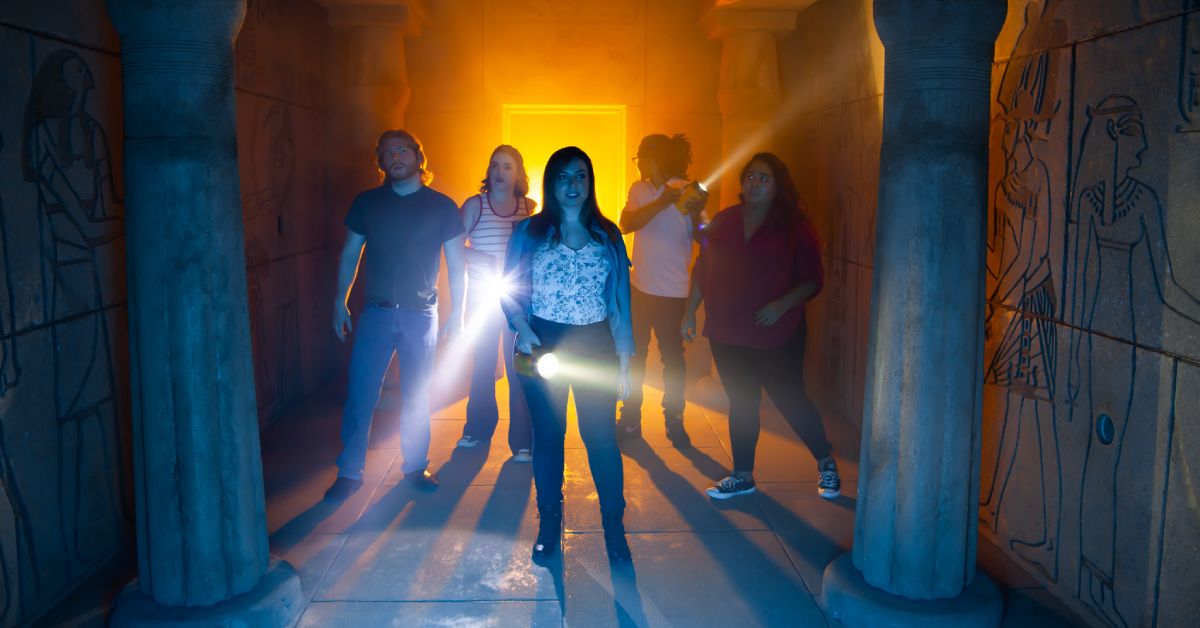 group of people inside of a tomb themed attraction