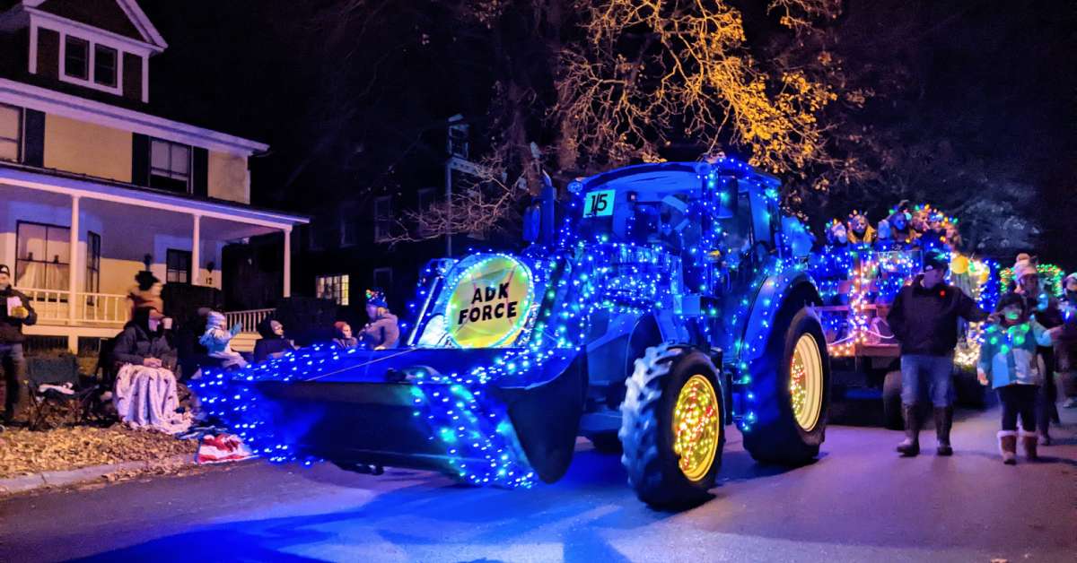 tractor decorated with holiday lights in a street parade