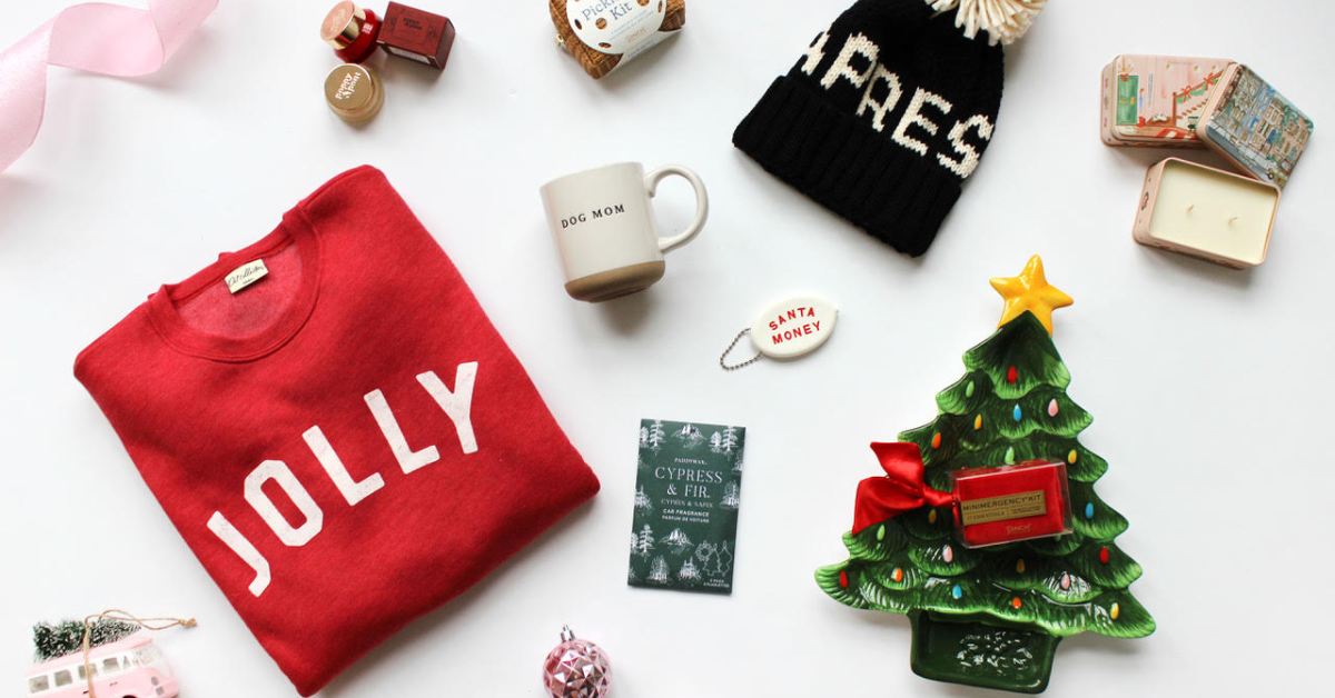 collection of holiday gifts like a shirt, mug, tree dish, and more