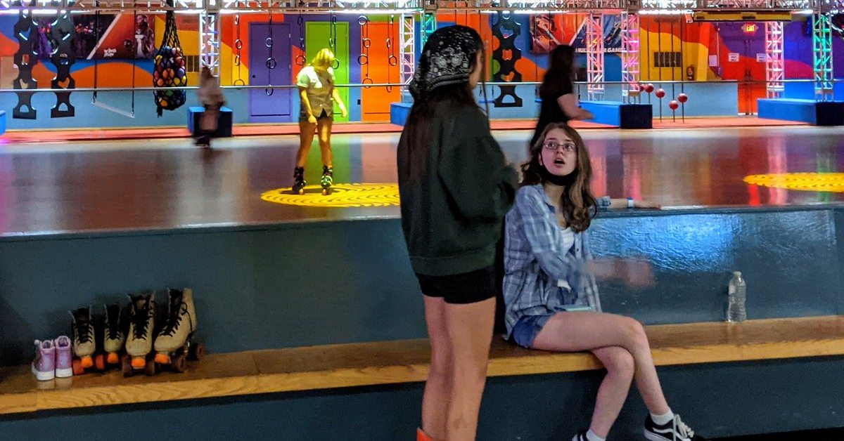 two young girls in front of roller skating rink at the fun spot