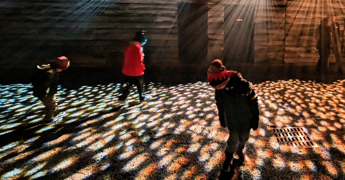 blurry kids in lights at lake george winter's dream