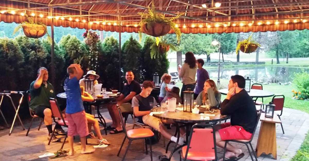 group of people enjoying dinner on a restaurant patio