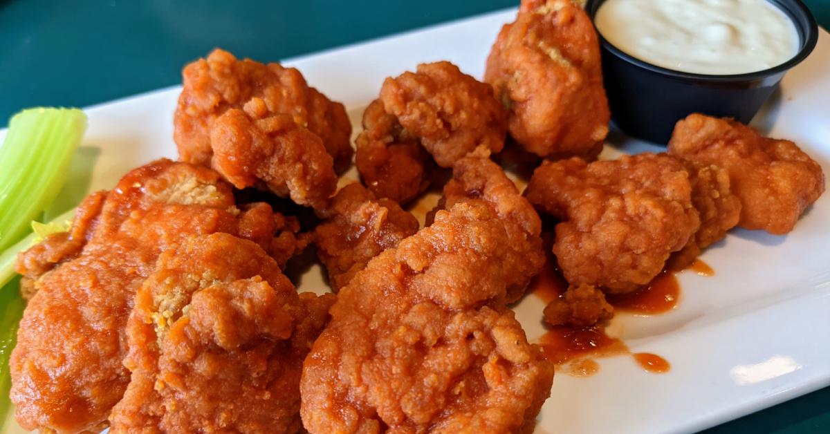 wings on a plate with a side of ranch and celery