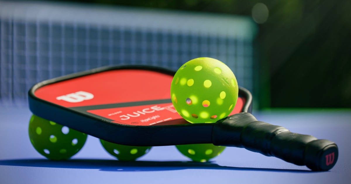 pickleball paddle and ball on the court
