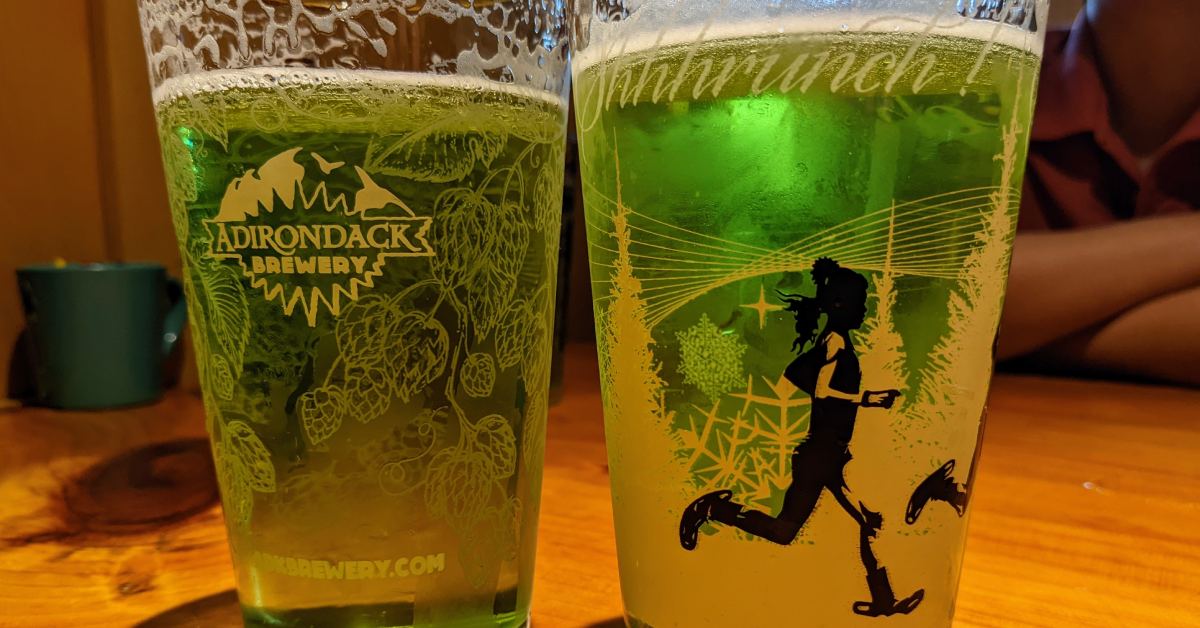 two glasses with green beer