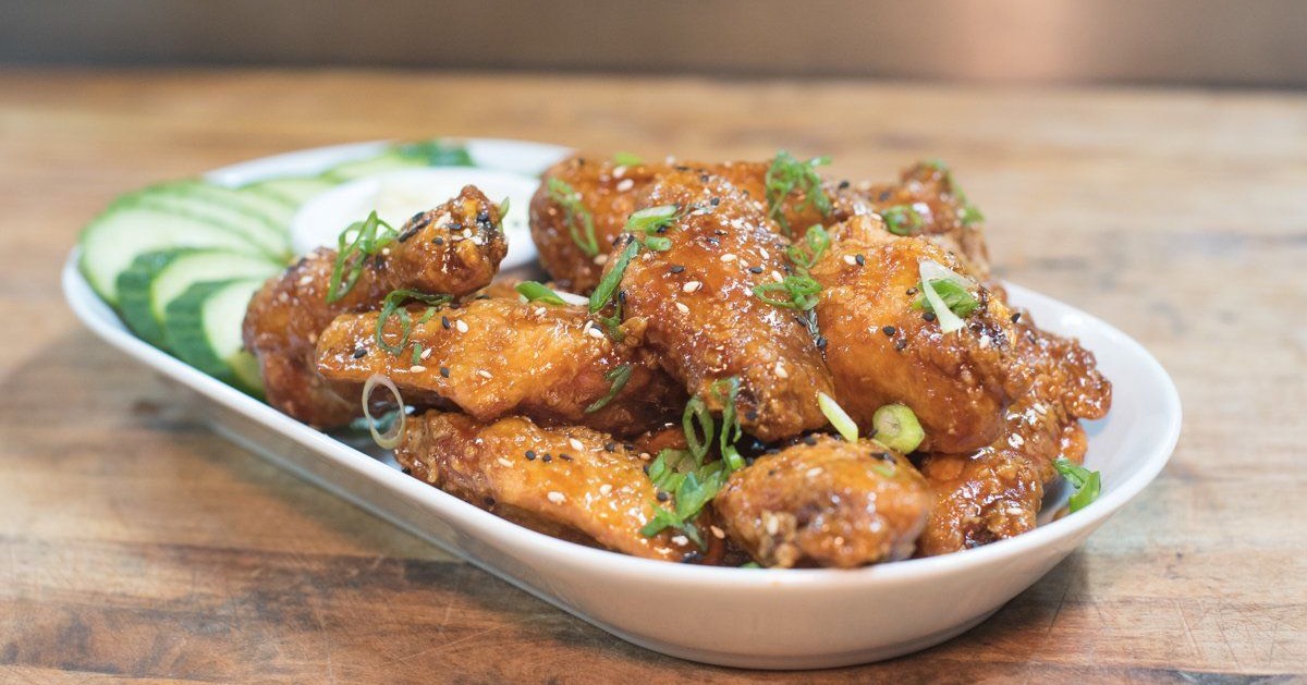 plated chicken wings with cucumbers and ranch