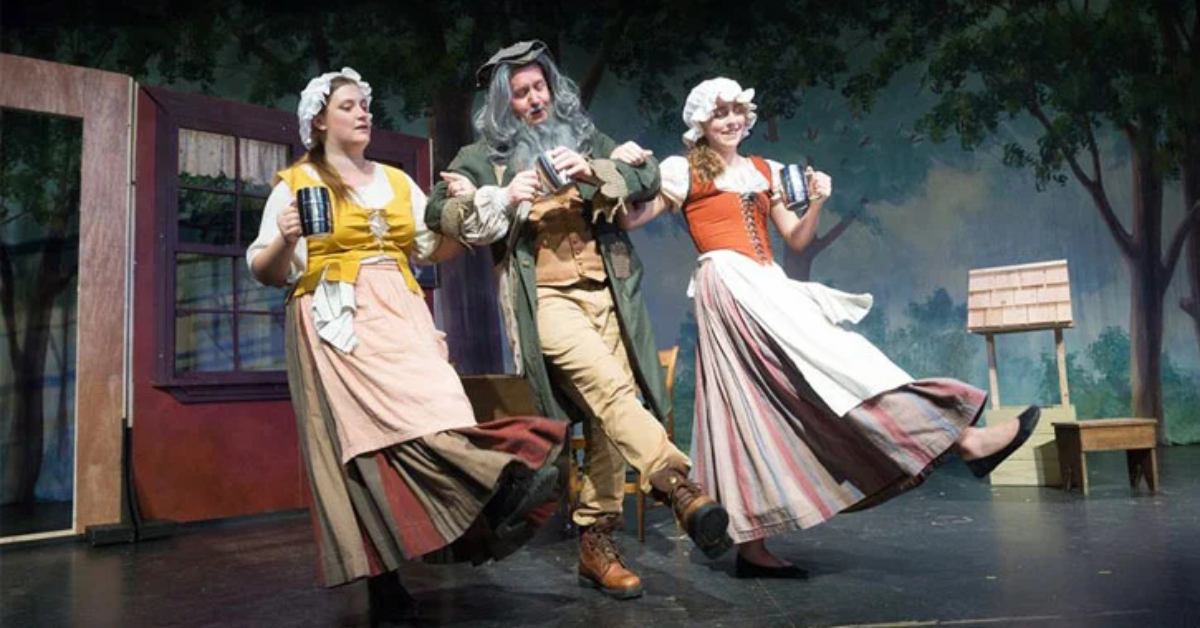 three people dancing on stage