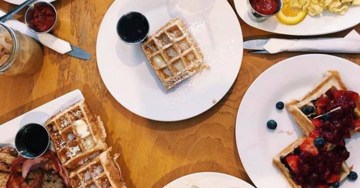 view of plates of breakfast food such as waffles and berries