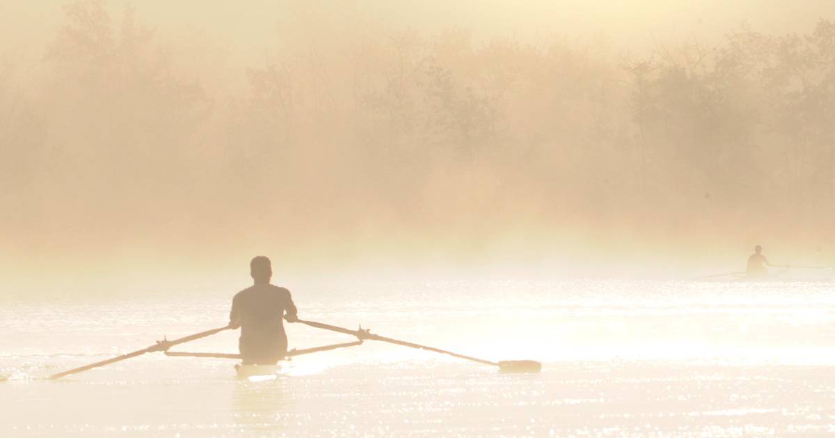 two canoes on water at dusk